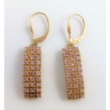 A pair of rectangular ear pendants, set with pink stones, the fittings stamped '375' (combined gross