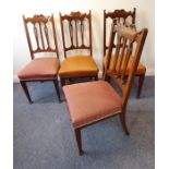 A set of four Edwardian walnut dining chairs; stuffover seats and square tapering legs terminating