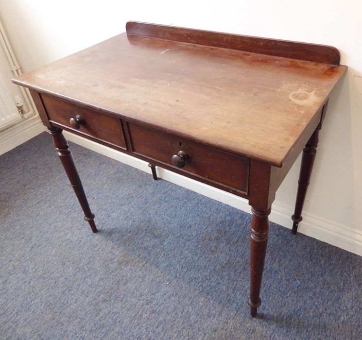 A mid-19th century mahogany side/writing table; the overhanging top with galleried back above two