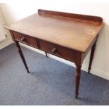 A mid-19th century mahogany side/writing table; the overhanging top with galleried back above two