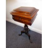 A mid-19th century rosewood teapoy; the sarcophagus-style hinged top opening to reveal two removable