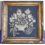 A gilt-framed and glazed early 19th century needlework study depicting various flowers emanating