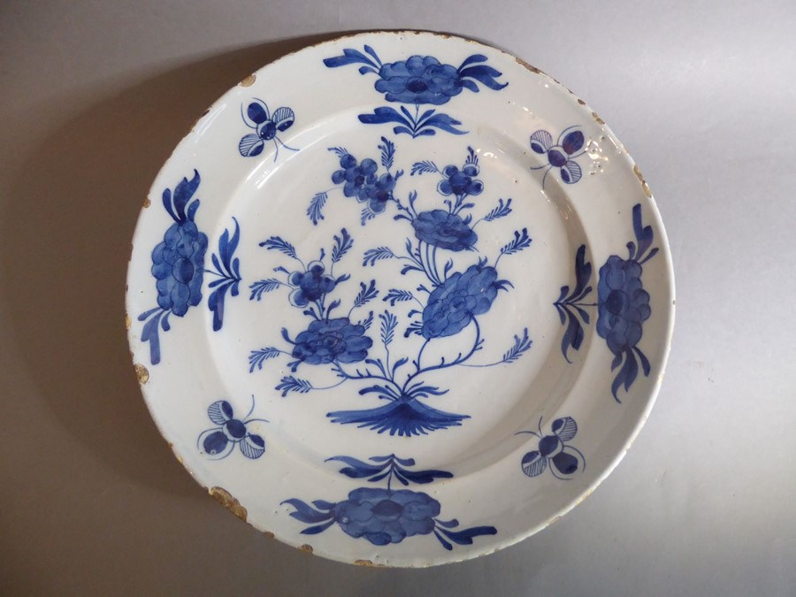 A large 18th century circular tin-glazed earthenware dish; hand painted in blue and white - Image 2 of 6