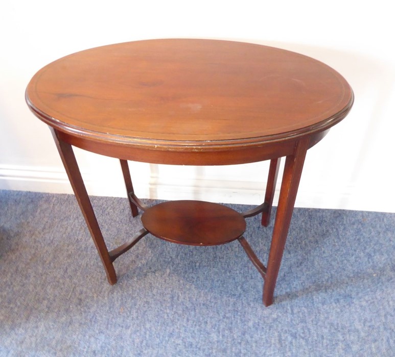 An Edwardian oval mahogany and boxwood-strung occasional table on square tapering legs united by