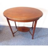 An Edwardian oval mahogany and boxwood-strung occasional table on square tapering legs united by