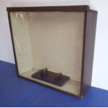 A large glazed display case with interior wooden plinth, probably for the display of a model