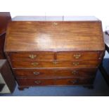 A late 18th century mahogany writing bureau of large proportions; the sloping cross-banded fall
