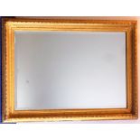 A 19th century gilded picture frame with later hand-bevelled mirror plate (frame size 100cm x