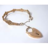 A 9-carat yellow-gold bracelet unusually modelled with filigree lozenges, with safety chain and