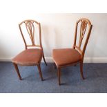 A pair of Edwardian satinwood Sheraton Revival salon-style chairs; pierced splats and square