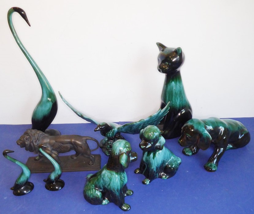Eight green glazed ceramic animals including dogs, a cat and an open-winged bird (the tallest 46.5cm