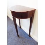 A demi-lune mahogany console table with crossbanded top above three square tapering legs terminating