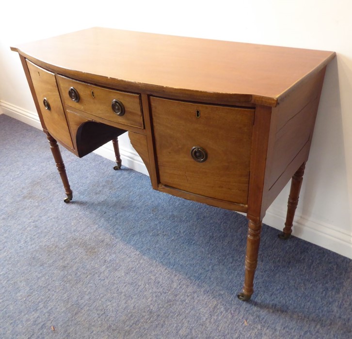 An early 19th century bow-fronted mahogany sideboard of small proportions; the central drawer