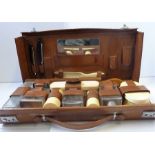 A early 20th century gentleman's leather-cased travelling vanity set to include a mirror, shoe horn,