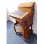 A 19th century walnut and boxwood-strung Davenport desk; the angular superstructure decorated with a