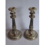 A pair of early 19th century Sheffield plated candlesticks engraved with armorial Latin legend and