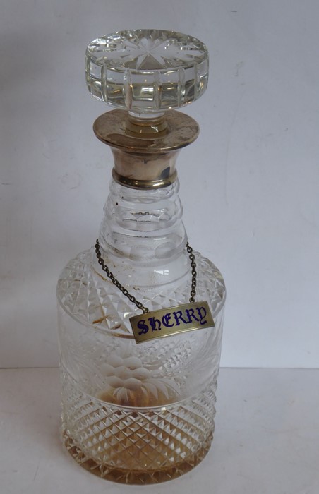 A cut-glass cylindrical decanter with mushroom-style stopper and hallmarked silver neck, also with