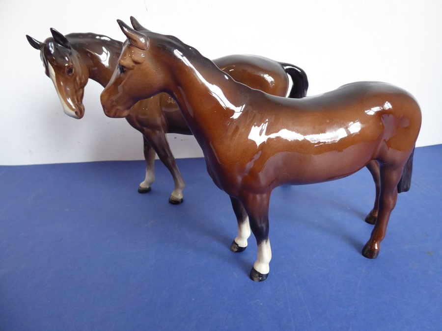 Two Beswick horses; brown glaze, one standing four square the other walking and with head turned