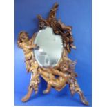 A Florentine-style carved softwood (possibly lime) wall-hanging looking glass; probably 19th