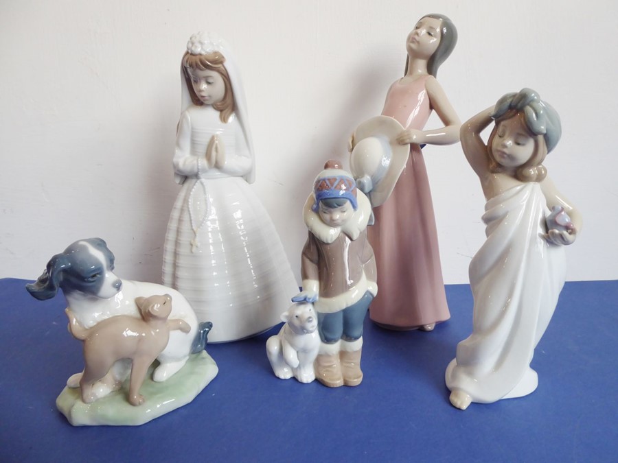 Three Lladro and two Nao porcelain figures; the Nao figures of a girl in first communion dress (23cm