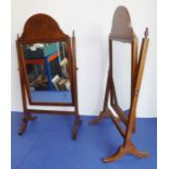 A pair of early 20th century walnut-framed toilet mirrors (differing brass finials)