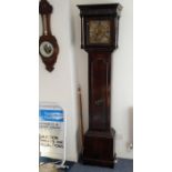 An 18th century 30-hour oak longcase clock; ogee-style cornice above a blind fret carved frieze