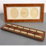 An Addison Ross (London) triple-oval photograph frame in herringbone-banded walnut (28.5cm wide x