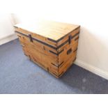 A large pine box with steel strapping and four industrial castors (64cm high x 92cm wide x 50cm