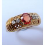 A dress ring; the ornate gallery centrally set with an oval orange stone with two circular-cut white