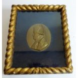 An oval 19th century bronze relief of Napoleon in profile; signed 'David', rope-twist glazed gilt