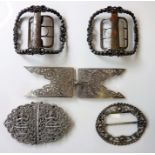 A good selection of buckles including a Siamese-style silver buckle, further white-metal buckles and
