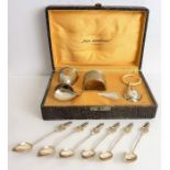 A cased Spanish silver (0.800 grade) egg cup, spoon, napkin ring and child's rattle with teether (