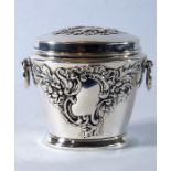 A late Victorian silver miniature tea caddy with embossed decoration and ring handles; James and
