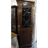 A George III-style freestanding mahogany corner cupboard; single glazed door with astragal glazing