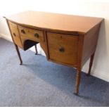 An early 19th century bow-fronted mahogany sideboard of small proportions; the central drawer