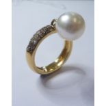 A diamond-set and cultured pearl band ring, the top section pavé-set with brown brilliant-cut