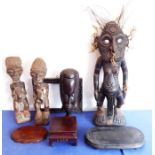 Four African figural carvings and four items of treen: the African carvings comprising a male figure