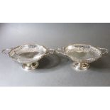 A cased pair of two-handled hallmarked silver bon-bon dishes; reticulated borders and spreading