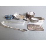 Six small pieces of silver bijouterie: a scallop-shaped caddy spoon; an oval napkin ring with