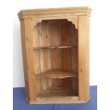 An early 20th century hanging pine corner cupboard with two shelves (57.5cm wide x 73.5cm high)
