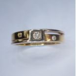 A diamond-set two-coloured gold ring, the top section set with three circular-cut diamonds, the