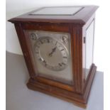 An early 20th century mahogany-cased eight-day mantle clock; the hand-bevelled glazed door enclosing