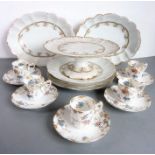 An Edwardian porcelain part dessert service comprising comport, three plates and two boat-shaped