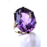 An amethyst single stone ring, the oval mixed-cut amethyst (measuring 2.2cm x 1.5cm), claw-set to