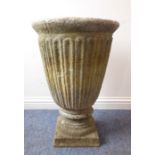 A large reconstituted stone Classical-style urn on stand; the tapering circular body with vertical