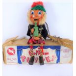 A boxed Pelham puppet dressed as a Scottish Highlander in kilt (the box probably a replacement)