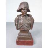 A small 19th century bronzed shoulder-length bust of Napoleon, upon square red marble base (9cm