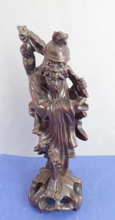 A late 19th century well patinated Chinese hardwood carving of a smiling fisherman (small crack to - Image 2 of 8