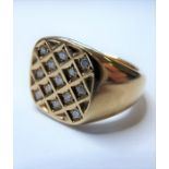 A diamond-set signet ring, the shaped square plaque of trellis design, each containing a brilliant-