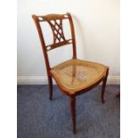 A single Edwardian period satinwood revival bedroom chair; the top rail decorated with roses above a